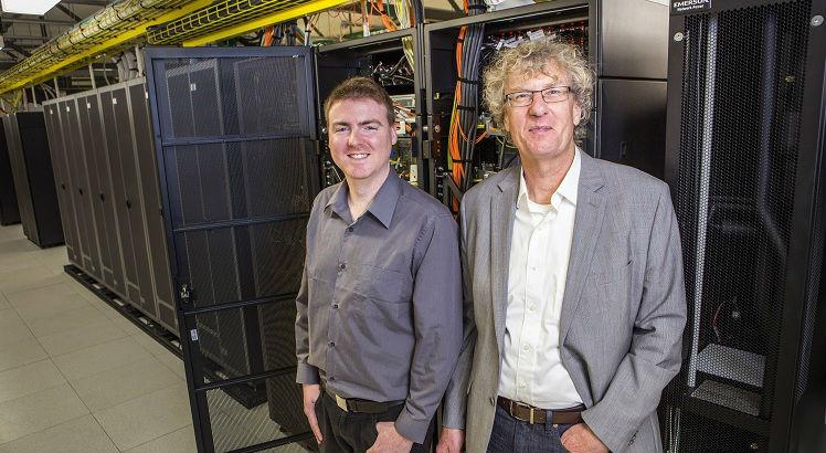 This handout photo taken on September 6, 2016 and released on September 26, 2016 shows University of Canterbury alumni composer Jason Long (L) and professor Jack Copeland (R) in the UNIVER Blue Gene computer area.
New Zealand researchers said on September 26 they have restored the first recording of computer-generated music, created in 1951 on a gigantic contraption built by British genius Alan Turing. / AFP PHOTO / UNIVERSITY OF CANTERBURY / STR / -----EDITORS NOTE --- RESTRICTED TO EDITORIAL USE - MANDATORY CREDIT "AFP PHOTO / UNIVERSITY OF CANTERBURY" - NO MARKETING - NO ADVERTISING CAMPAIGNS - DISTRIBUTED AS A SERVICE TO CLIENTS - NO ARCHIVES