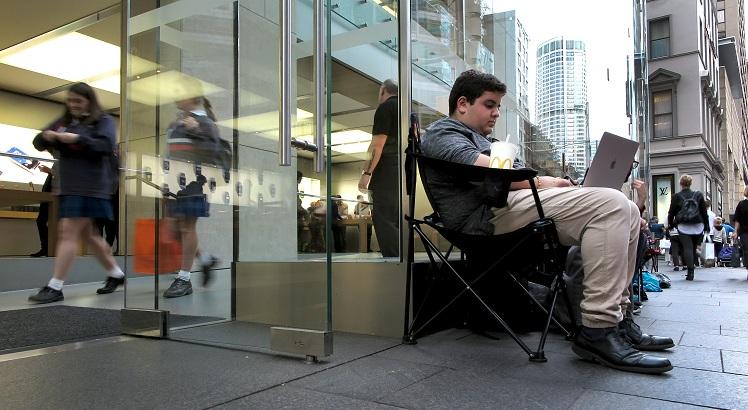 Marcus Barsoum (R), 16, sits in line outside Apple's flagship store in Sydney's central business district on 14 September, 2016.
 People have started queuing outside Apple stores for the September 16 release of the new iPhone 7. / AFP / WILLIAM WEST