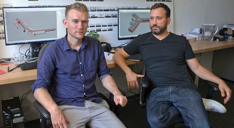 Sitting in front of screens showing Syria's Saidnaya military prison, recreated in harrowing 3D detail, architectural researcher Stefan Laxness (L) and Principal Investigator Eyal Weizman (R) pose for a photograph in their office at Goldsmiths, University in London on August 26, 2016. Human rights campaigners Amnesty International are the latest organisation to call on Forensic Architecture's (FA) expertise. Its interdisciplinary laboratory specialises in producing analysis and evidence to be used in human rights cases brought to international courts, with architecture a key tool in helping to accurately recreate events occurring in chaotic surroundings.  - TO GO WITH AFP STORY BY MYRIAM BENEZZAR
 / AFP / JUSTIN TALLIS / TO GO WITH AFP STORY BY MYRIAM BENEZZAR
